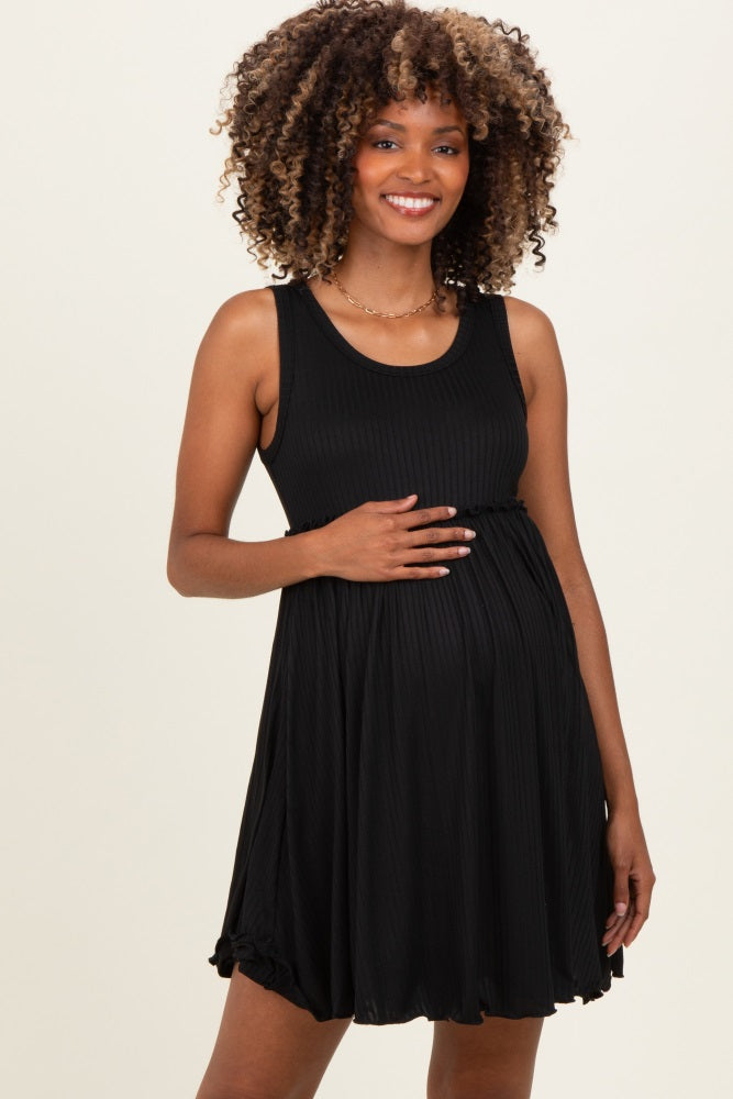 woman wearing a black ribbed maternity dress and holding her baby bump