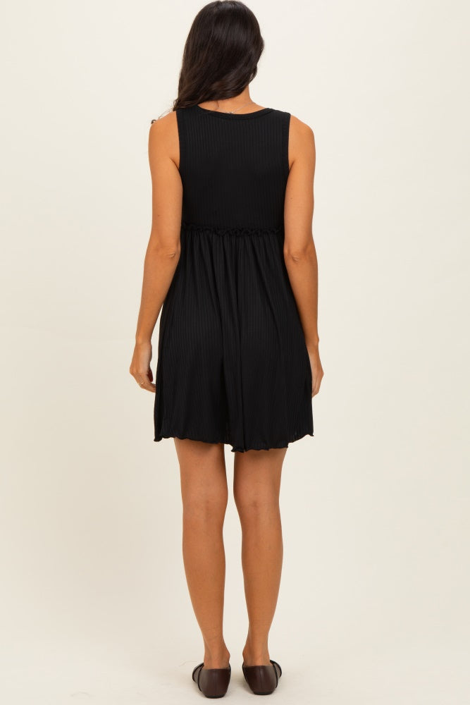 woman wearing a black sleeveless romper with a cinched waist, viewed from the back.
