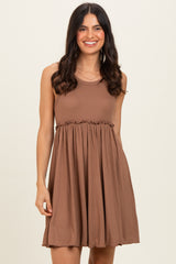 woman wearing a brown sleeveless ribbed dress with a cinched waist and flared skirt