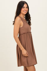 woman wearing a brown ribbed sleeveless dress with a relaxed fit and gathered waistline