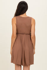 woman wearing a brown sleeveless ribbed dress with a cinched waist and flowing skirt, back view