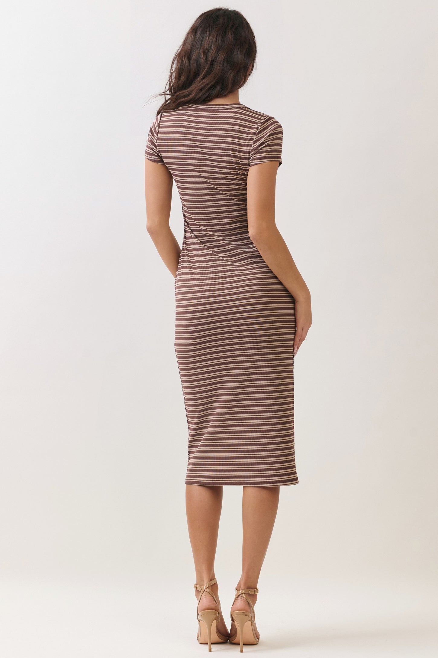 woman wearing a brown striped midi dress with short sleeves and a fitted silhouette, seen from the back