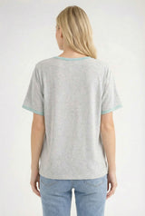 woman wearing a gray short sleeve t-shirt with teal trim and light blue jeans, viewed from the back