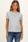 woman wearing a light gray maternity t-shirt with teal trim and side slits, showing a small baby bump