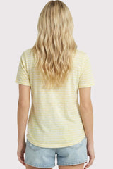 woman wearing a yellow striped short sleeve t-shirt with a rounded hem and casual denim shorts