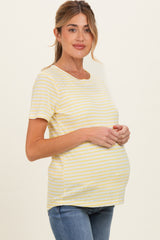 woman wearing a yellow and white striped maternity top with a visible baby bump