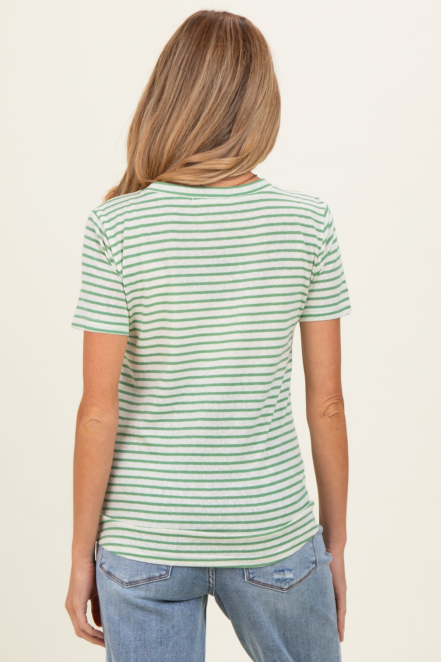 woman wearing a light green and white striped maternity t-shirt, view of the back