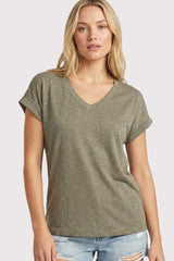 woman wearing an olive green short sleeve v-neck t-shirt and distressed denim shorts