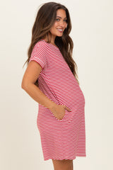 woman wearing a red and white striped maternity dress with pockets and a visible baby bump