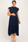woman wearing a navy blue maternity maxi dress with short ruffled sleeves and a smocked bodice, showing her baby bump