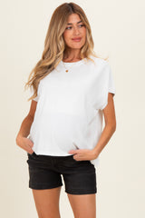 woman wearing a white short sleeve maternity top with a relaxed fit and a visible baby bump