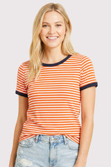 woman wearing an orange and white striped t-shirt with navy blue trim and light blue distressed jeans
