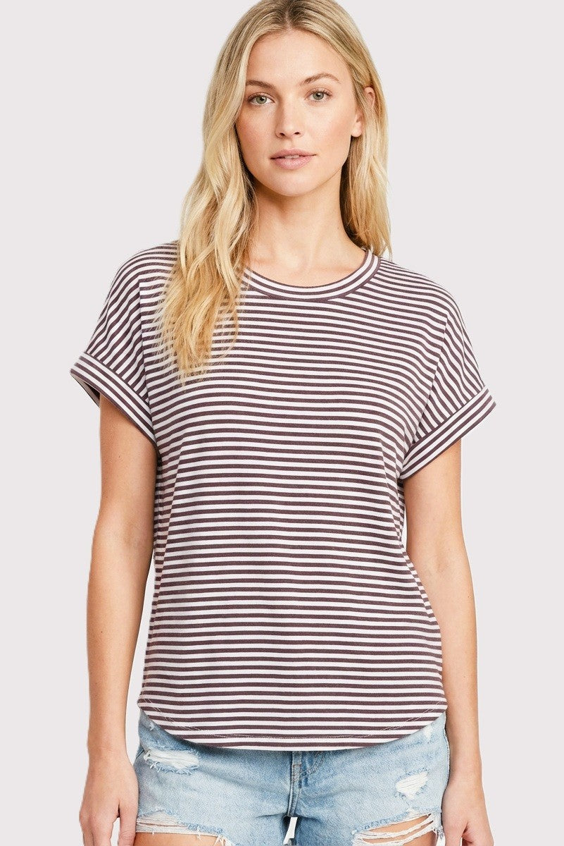 woman wearing a maroon and white striped short sleeve t-shirt with rolled cuffs and light blue distressed denim shorts