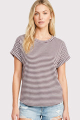 woman wearing a maroon and white striped short sleeve t-shirt with rolled cuffs and light blue distressed denim shorts