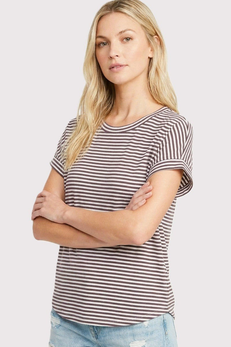 woman wearing a brown and white striped short sleeve t-shirt with rolled cuffs and a relaxed fit