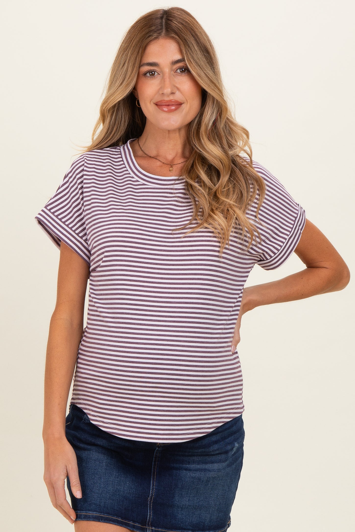 woman wearing a maternity striped short sleeve top with a round neckline and a relaxed fit