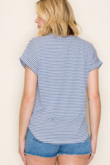 woman wearing a navy and white striped short sleeve top with rolled cuffs and denim shorts