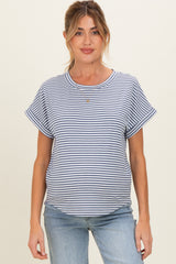 woman wearing a navy and white striped maternity top with rolled short sleeves and a relaxed fit, showing her baby bump