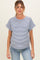 woman wearing a navy and white striped maternity top with rolled short sleeves and a relaxed fit, showing her baby bump