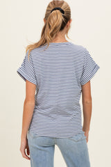 woman wearing a navy and white striped short sleeve maternity top, seen from the back with casual jeans