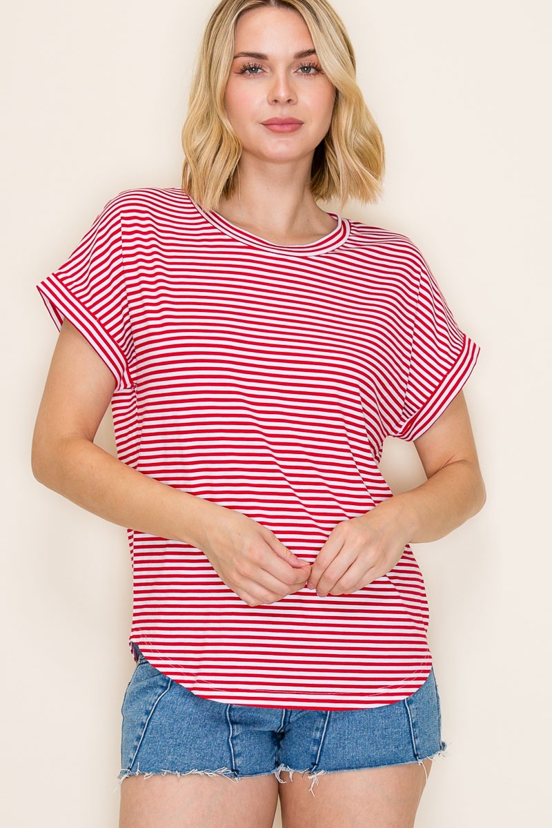 woman wearing a red and white striped short sleeve top with rolled cuffs and denim shorts