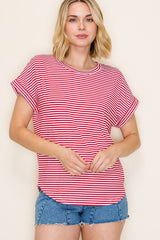 woman wearing a red and white striped short sleeve top with rolled cuffs and denim shorts