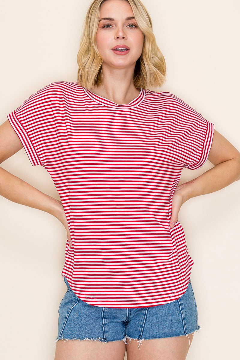 woman wearing a red and white striped short sleeve top and blue denim shorts