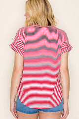 woman wearing a red and white striped short sleeve top with rolled sleeves and a curved hem, viewed from the back