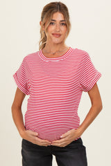 woman wearing a red and white striped maternity top and holding her baby bump