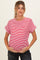 woman wearing a red and white striped maternity top and holding her baby bump