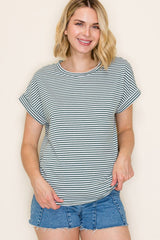 woman wearing a light green and white striped short sleeve t-shirt with rolled sleeves and denim shorts