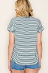 woman wearing a striped short sleeve top with rolled cuffs and denim shorts, shown from the back