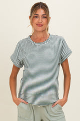 woman wearing a green and white striped maternity t-shirt with rolled sleeves and relaxed fit, holding her baby bump