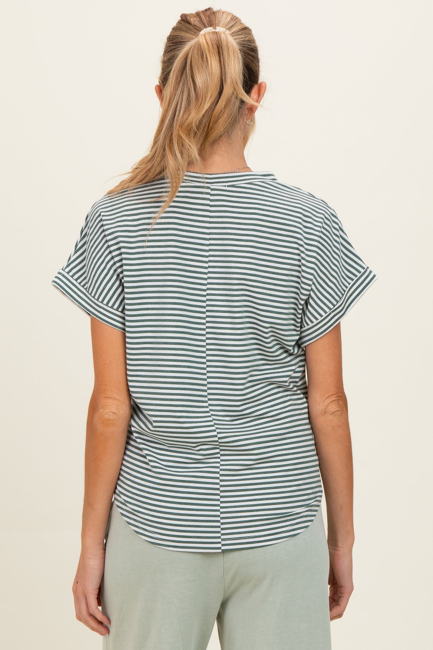 woman wearing a striped maternity top with short sleeves and a rounded hem, seen from the back