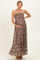 woman wearing a brown floral maternity maxi dress, showing her baby bump with a halter neck and tiered skirt