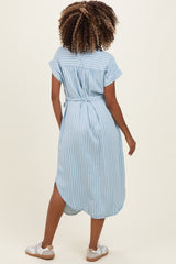 woman wearing a light blue striped maternity dress with short sleeves and a tie waist, showing her back