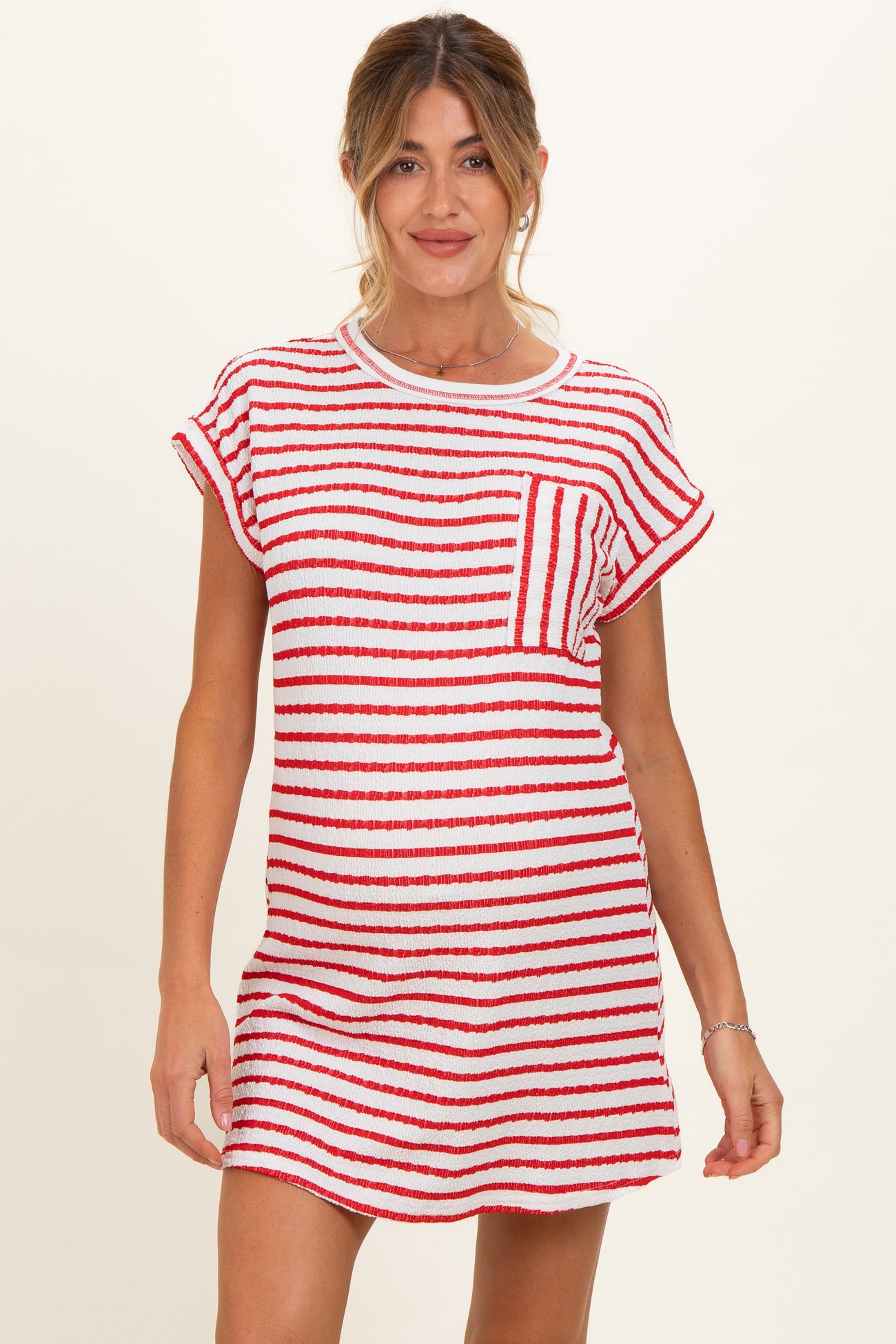 woman wearing a red and white striped maternity dress with short sleeves and a relaxed fit, showcasing her baby bump
