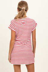 woman wearing a red and white striped maternity dress, showing the back view and a short sleeves design