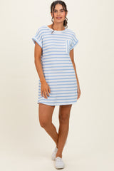 woman wearing a light blue and white striped short sleeve dress with a pocket and white sneakers