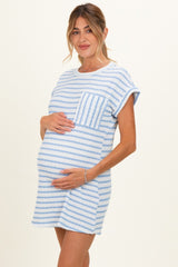 woman wearing a light blue and white striped maternity dress with short sleeves and a front pocket, holding her baby bump