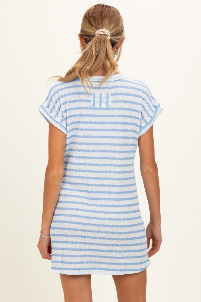 woman wearing a blue and white striped maternity dress with short sleeves, view from the back