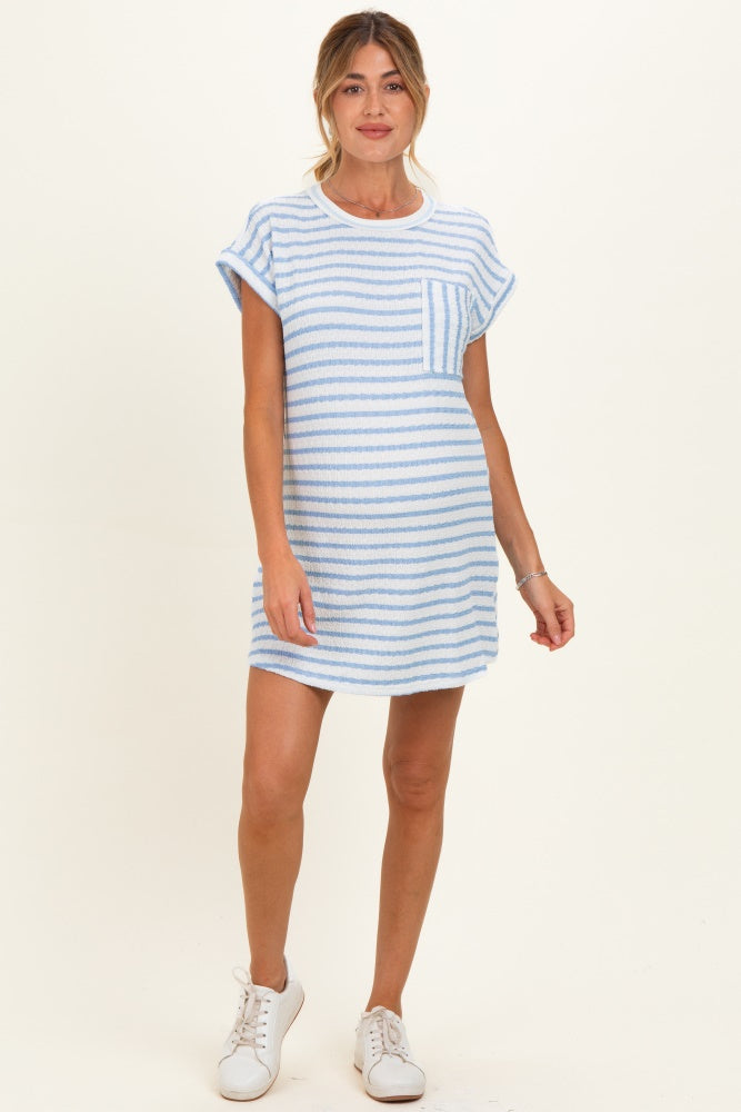 woman wearing a light blue striped maternity dress with short sleeves and a front pocket