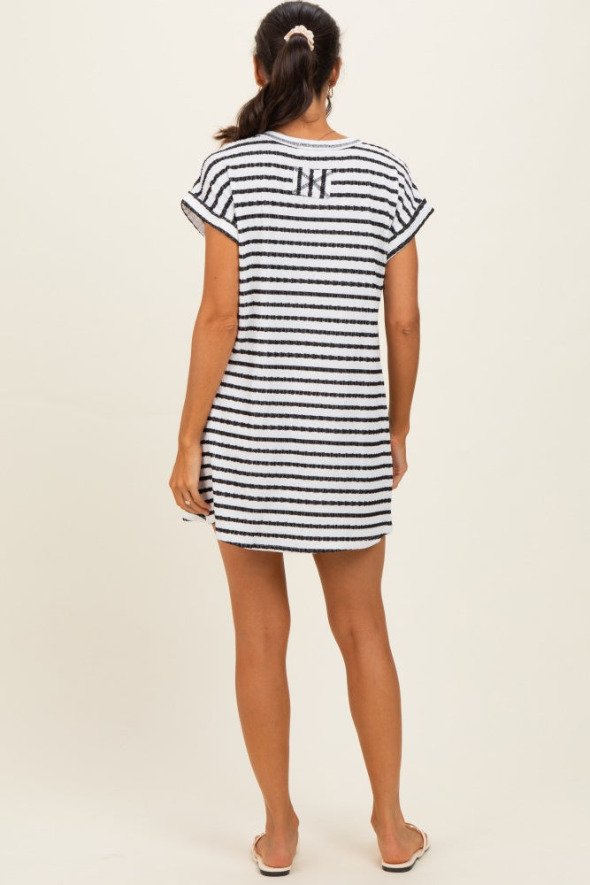 woman wearing a striped black and white beach cover-up with short sleeves and a relaxed fit