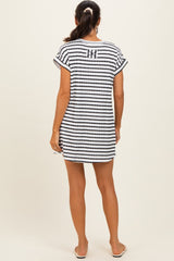 woman wearing a striped black and white beach cover-up with short sleeves and a relaxed fit