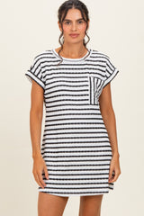 woman wearing a black and white striped short sleeve dress with a pocket detail