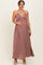 woman wearing a mauve maternity maxi dress with a flattering empire waist and holding her baby bump