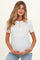 woman wearing a white short sleeve maternity top with lace-up detailing and a visible baby bump