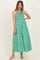 woman wearing a green and white striped maternity maxi dress with smocked bodice and wide hem