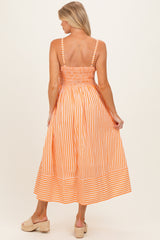 woman wearing an orange and white striped maternity maxi dress with smocked back and adjustable straps