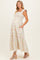 woman wearing a floral maternity maxi dress with smocked bodice and ruffled straps, showing her baby bump